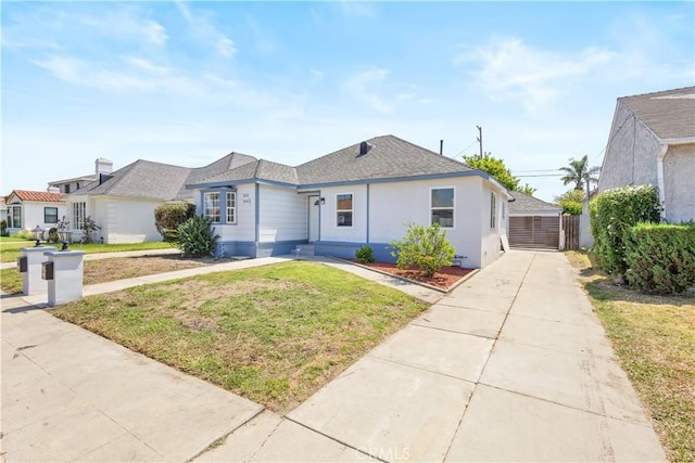 3876 Olmsted Ave, Los Angeles, CA 90008 - view of front of house with a front lawn, roof with shingles, and stucco siding