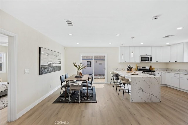 3876 Olmsted Ave, Los Angeles, CA 90008 - dining space with light wood-style floors and recessed lighting