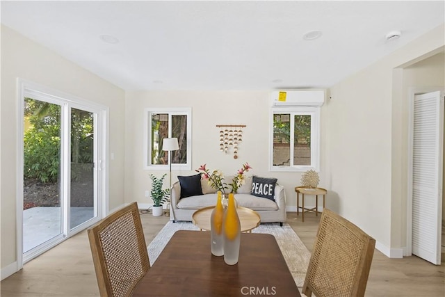 3876 Olmsted Ave, Los Angeles, CA 90008 - dining space featuring healthy amount of natural light, light wood-style floors, and an AC wall unit