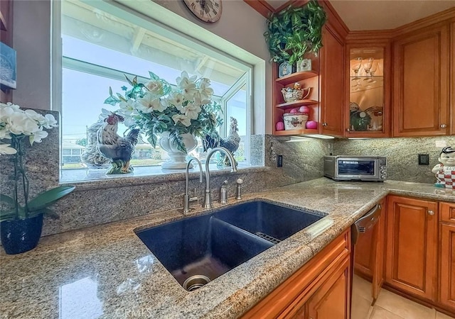 17213 Horace St, Granada Hills, CA 91344 - kitchen with stainless steel dishwasher, light stone counters, and brown cabinetry