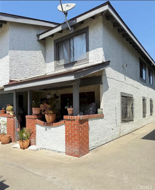 1239 W Rosecrans, Gardena, CA 90247 - rear view of property featuring stucco siding and a patio area