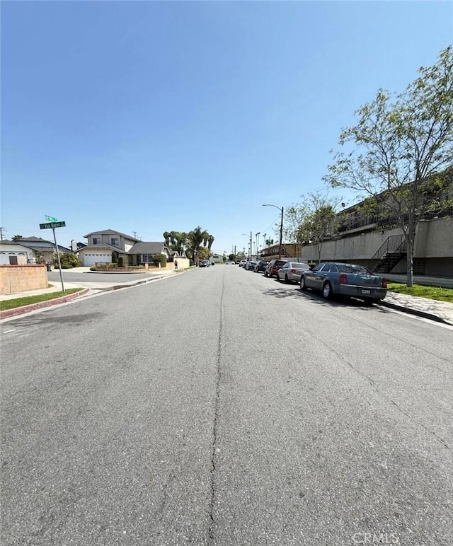 1239 W Rosecrans, Gardena, CA 90247 - view of asphalt road featuring sidewalks, curbs, and street lighting