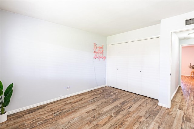 1209 E 1st St, Tustin, CA 92780 - unfurnished bedroom with wood finished floors and a closet
