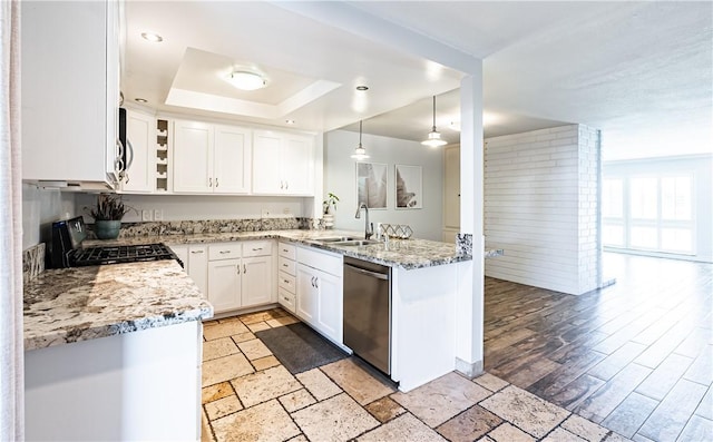 1209 E 1st St, Tustin, CA 92780 - kitchen featuring stainless steel appliances, a raised ceiling, light stone counters, white cabinetry, and a peninsula