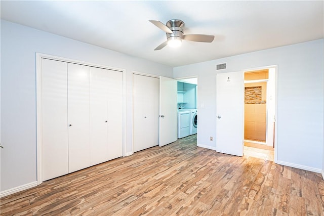 1209 E 1st St, Tustin, CA 92780 - unfurnished bedroom featuring two closets, independent washer and dryer, light wood-type flooring, ensuite bath, and a ceiling fan