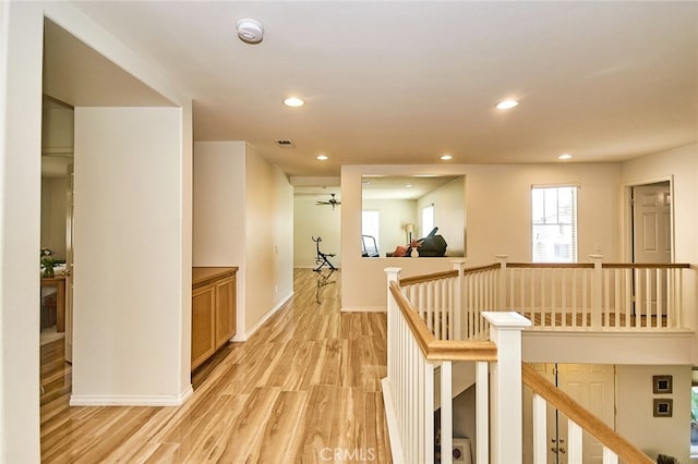 13637 Aspen Leaf Ln, Eastvale, CA 92880 - corridor with an upstairs landing, light wood-style flooring, and recessed lighting