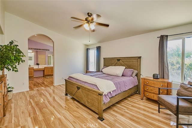 13637 Aspen Leaf Ln, Eastvale, CA 92880 - bedroom with light wood-style floors, arched walkways, and ensuite bath