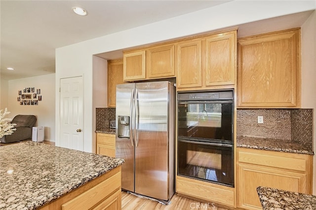 13637 Aspen Leaf Ln, Eastvale, CA 92880 - kitchen with stainless steel fridge, backsplash, stone counters, light brown cabinetry, and light wood-style floors