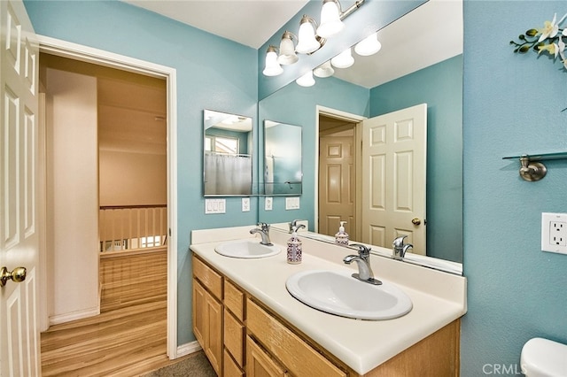 13637 Aspen Leaf Ln, Eastvale, CA 92880 - bathroom featuring double vanity and wood finished floors