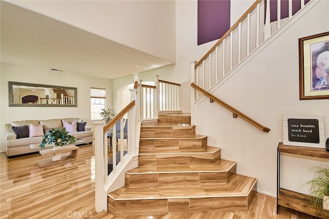 13637 Aspen Leaf Ln, Eastvale, CA 92880 - stairway featuring wood finished floors and a high ceiling