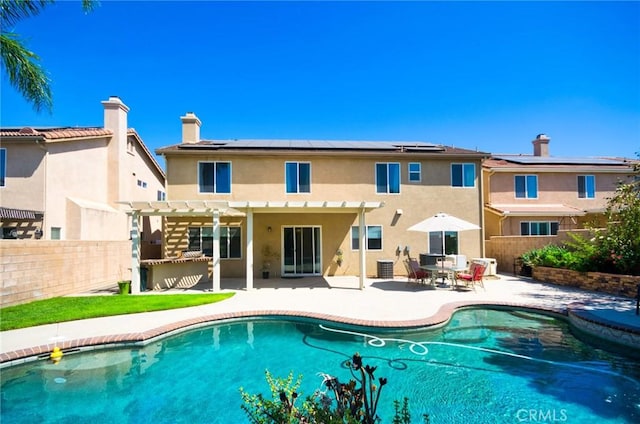 13637 Aspen Leaf Ln, Eastvale, CA 92880 - back of house featuring a pergola, a fenced backyard, solar panels, stucco siding, and a patio