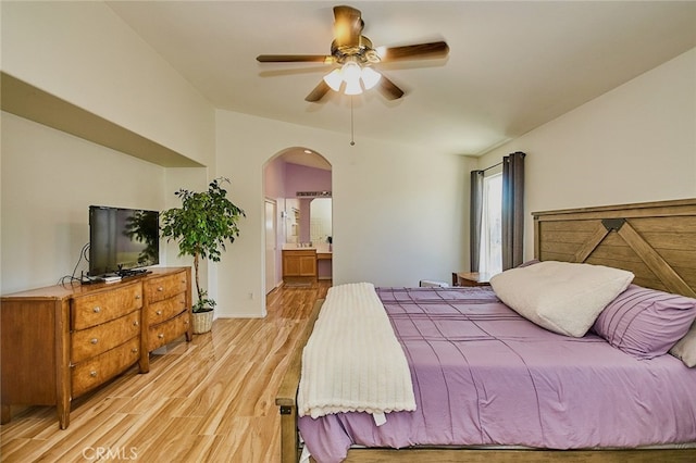 13637 Aspen Leaf Ln, Eastvale, CA 92880 - bedroom featuring arched walkways, light wood-style floors, ensuite bathroom, and a ceiling fan