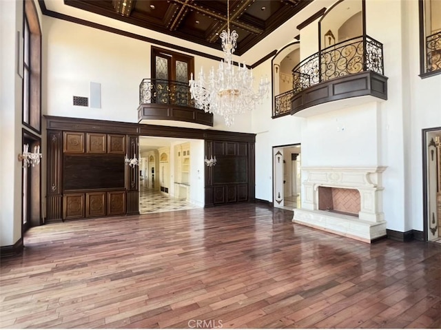 119 Furlong Ln, Bradbury, CA 91008 - unfurnished living room featuring a high ceiling, wood-type flooring, crown molding, coffered ceiling, and a chandelier
