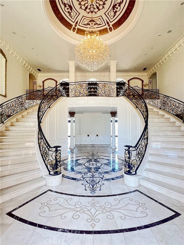 119 Furlong Ln, Bradbury, CA 91008 - staircase with inlaid floor details, a chandelier, a tray ceiling, crown molding, and a decorative wall
