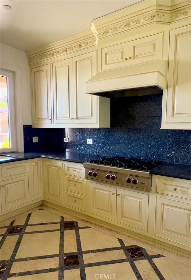 119 Furlong Ln, Bradbury, CA 91008 - kitchen featuring cream cabinetry, stainless steel gas stovetop, inlaid floor details, backsplash, and dark countertops