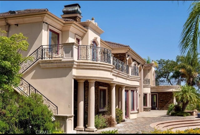 119 Furlong Ln, Bradbury, CA 91008 - rear view of property with a balcony, stucco siding, a patio area, and a chimney