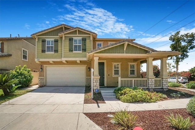 16202 Orion Ave, Chino, CA 91708 - craftsman-style house with covered porch, driveway, stucco siding, an attached garage, and stone siding