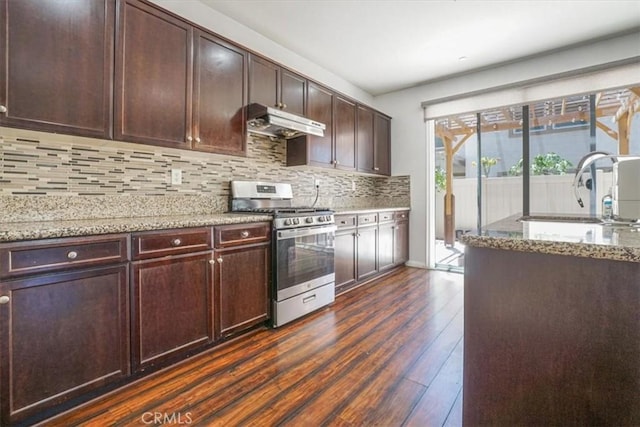 16202 Orion Ave, Chino, CA 91708 - kitchen with gas stove, under cabinet range hood, dark wood-style flooring, light stone countertops, and backsplash