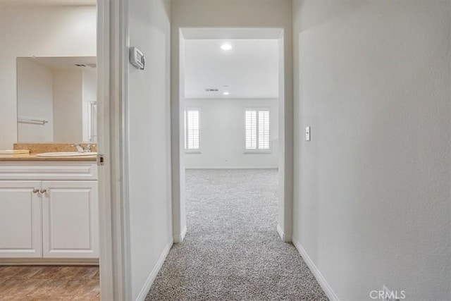 16202 Orion Ave, Chino, CA 91708 - hallway featuring a sink and light carpet