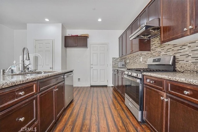 16202 Orion Ave, Chino, CA 91708 - kitchen featuring stainless steel appliances, range hood, dark wood-style floors, backsplash, and light stone counters