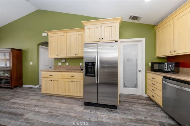 5935 Monte Vista Rd, Phelan, CA 92371 - kitchen with stainless steel appliances, lofted ceiling, light wood-type flooring, light brown cabinets, and light countertops