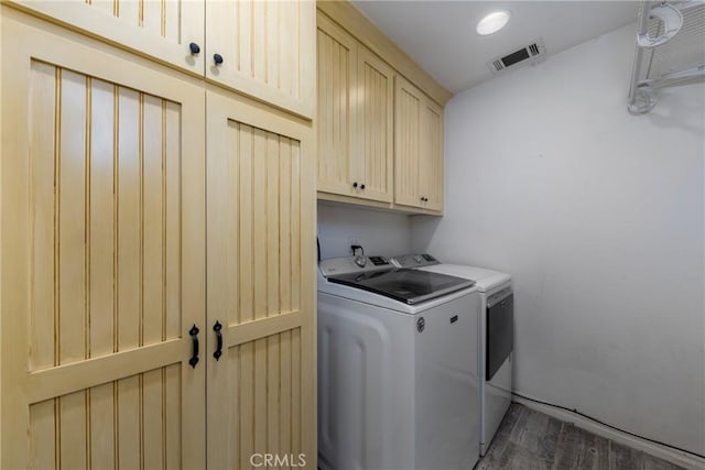 5935 Monte Vista Rd, Phelan, CA 92371 - laundry area featuring cabinet space, washer and dryer, and wood finished floors