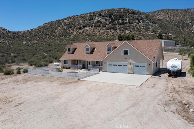 5935 Monte Vista Rd, Phelan, CA 92371 - view of front facade with concrete driveway, a garage, and a mountain view
