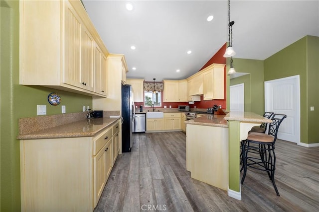 5935 Monte Vista Rd, Phelan, CA 92371 - kitchen featuring wood finished floors, a peninsula, a breakfast bar, stainless steel appliances, and hanging light fixtures