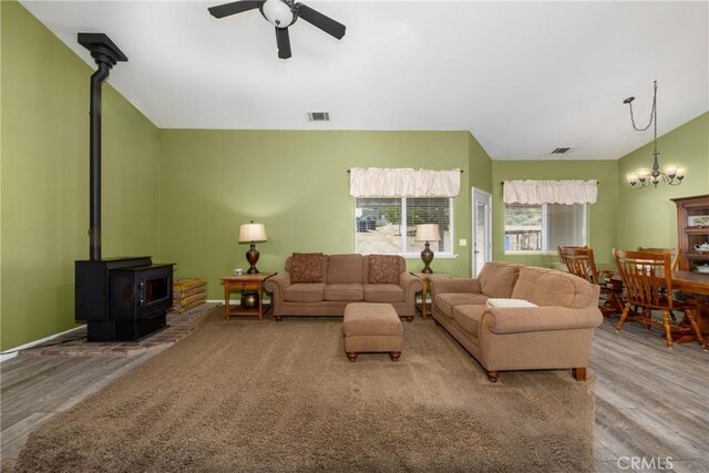 5935 Monte Vista Rd, Phelan, CA 92371 - living room with a wood stove, a ceiling fan, wood finished floors, and a chandelier