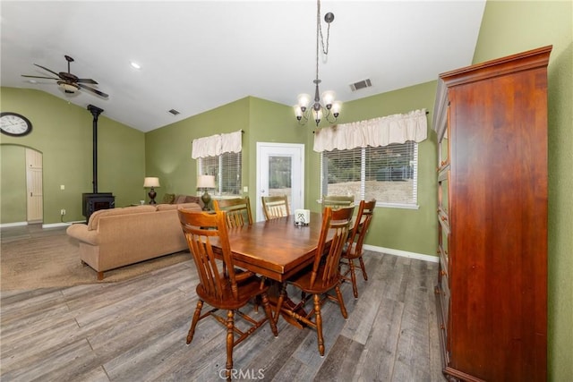 5935 Monte Vista Rd, Phelan, CA 92371 - dining room with vaulted ceiling, wood finished floors, a chandelier, a wood stove, and a ceiling fan