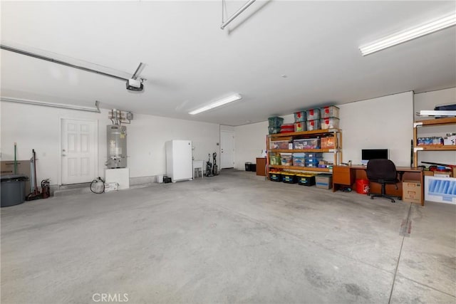 5935 Monte Vista Rd, Phelan, CA 92371 - garage featuring a garage door opener, an office area, and strapped water heater
