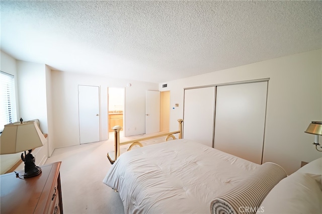 18560 Vanowen St Unit 27, Reseda, CA 91335 - carpeted bedroom with a textured ceiling, a closet, and ensuite bath