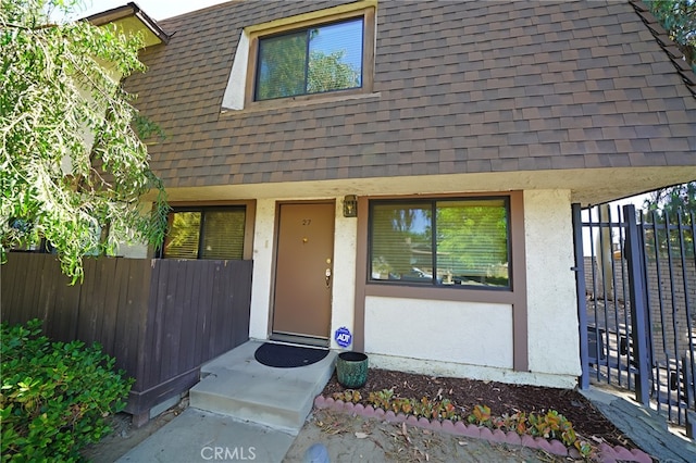 18560 Vanowen St Unit 27, Reseda, CA 91335 - property entrance featuring stucco siding and roof with shingles