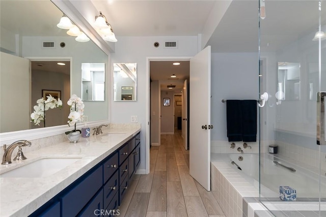 222 Monterey Rd Unit 1205, Glendale, CA 91206 - full bath with double vanity, a bath, wood finished floors, and a stall shower