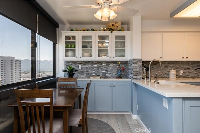 222 Monterey Rd Unit 1205, Glendale, CA 91206 - kitchen featuring tasteful backsplash, a ceiling fan, and white cabinets