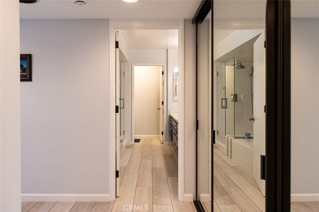 222 Monterey Rd Unit 1205, Glendale, CA 91206 - hallway featuring light wood-type flooring and baseboards