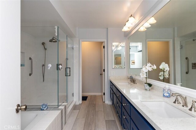222 Monterey Rd Unit 1205, Glendale, CA 91206 - full bathroom with a stall shower, double vanity, wood finished floors, and tiled tub