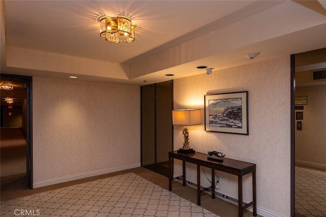222 Monterey Rd Unit 1205, Glendale, CA 91206 - corridor featuring a tray ceiling and a chandelier