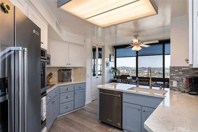 222 Monterey Rd Unit 1205, Glendale, CA 91206 - kitchen featuring stainless steel appliances, tasteful backsplash, ceiling fan, and light countertops