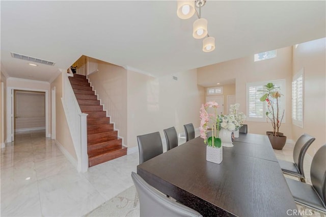 1528 W Delvale St, West Covina, CA 91790 - dining room with light marble finish floors, stairs, and ornamental molding