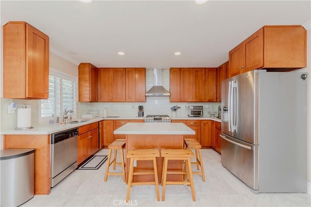 1528 W Delvale St, West Covina, CA 91790 - kitchen featuring appliances with stainless steel finishes, wall chimney range hood, a kitchen island, a kitchen bar, and light countertops