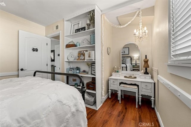 20072 Mural Cir, Huntington Beach, CA 92646 - bedroom featuring arched walkways, wood finished floors, and a chandelier