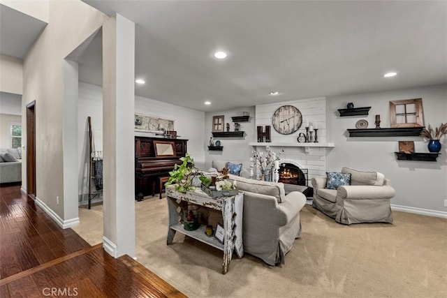 20072 Mural Cir, Huntington Beach, CA 92646 - living area with recessed lighting, a brick fireplace, and wood finished floors