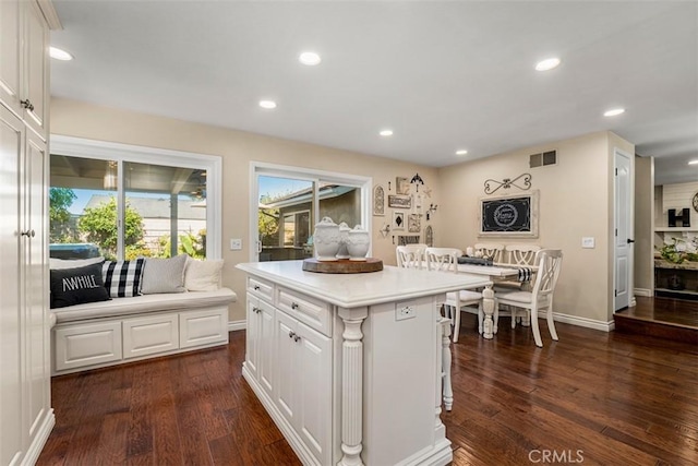 20072 Mural Cir, Huntington Beach, CA 92646 - kitchen with dark wood-style floors, white cabinets, recessed lighting, a kitchen island, and light countertops