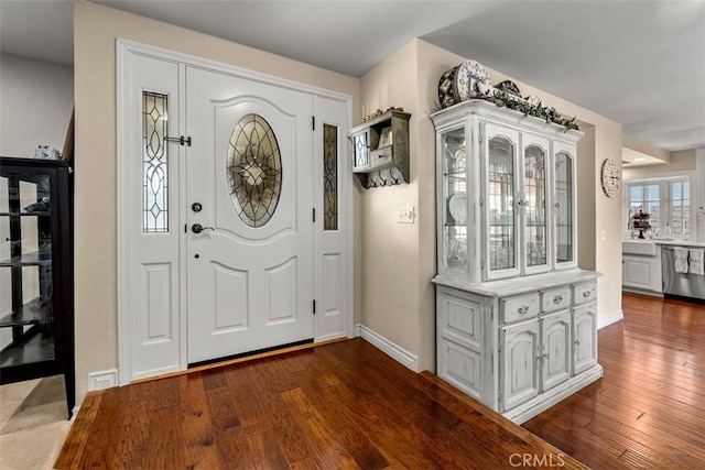 20072 Mural Cir, Huntington Beach, CA 92646 - foyer featuring dark wood-style flooring and baseboards