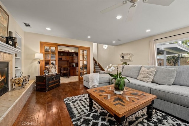 20072 Mural Cir, Huntington Beach, CA 92646 - living room featuring hardwood / wood-style floors, a tiled fireplace, stairway, ceiling fan, and recessed lighting