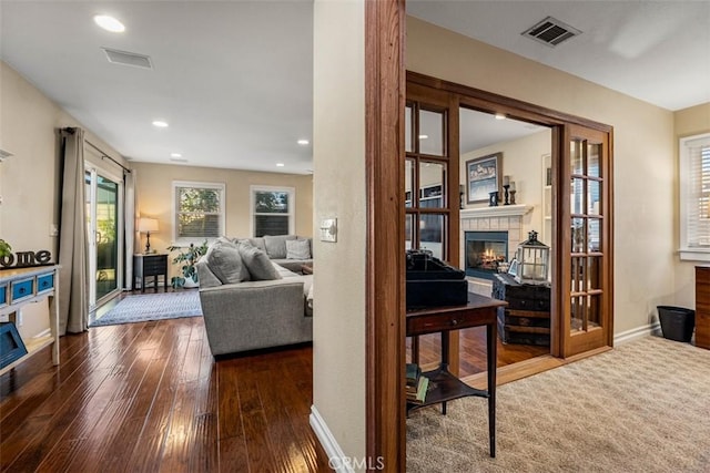 20072 Mural Cir, Huntington Beach, CA 92646 - living room featuring a tile fireplace, hardwood / wood-style flooring, and recessed lighting