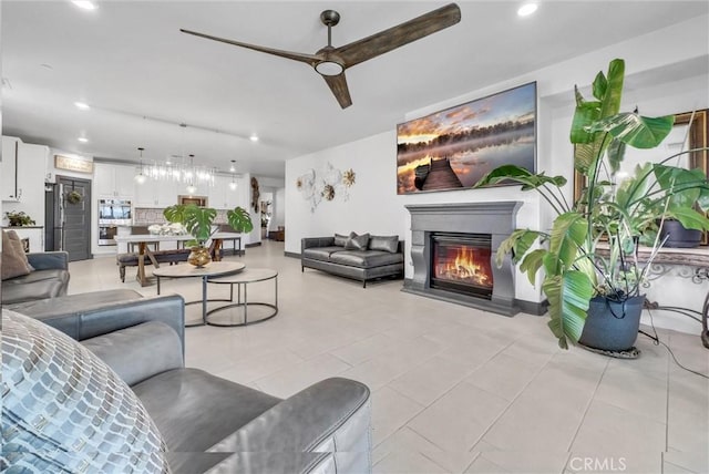 40569 Koa Ct, Temecula, CA 92591 - living room featuring a ceiling fan, a glass covered fireplace, recessed lighting, and light tile patterned floors