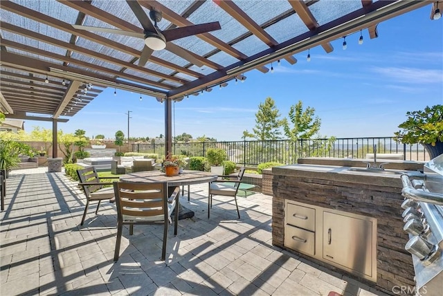 40569 Koa Ct, Temecula, CA 92591 - fenced backyard featuring a pergola, exterior kitchen, outdoor dining area, a patio, and a ceiling fan