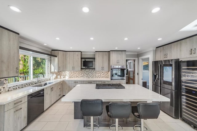 3526 Ticonderoga St, San Diego, CA 92117 - kitchen with stainless steel appliances, a breakfast bar, light tile patterned floors, modern cabinets, and ornamental molding
